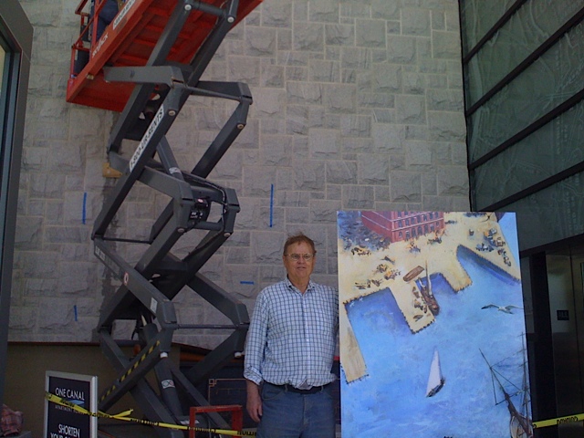 MCA President J Breen holding one panel of Dahill’s mural