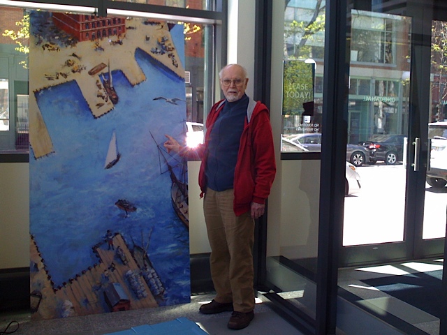 Artist Tom Dahill seeing one of six panels to be hung