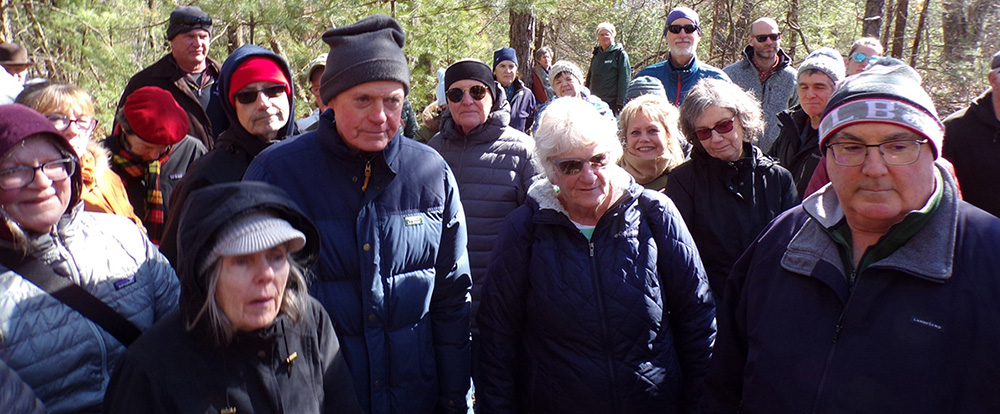 Walkers hearing the history of the smallpox memorial