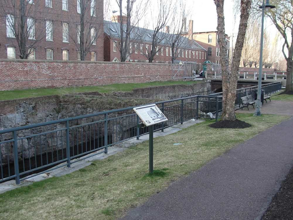 Sideview of towpath with interpretive panel on east bank